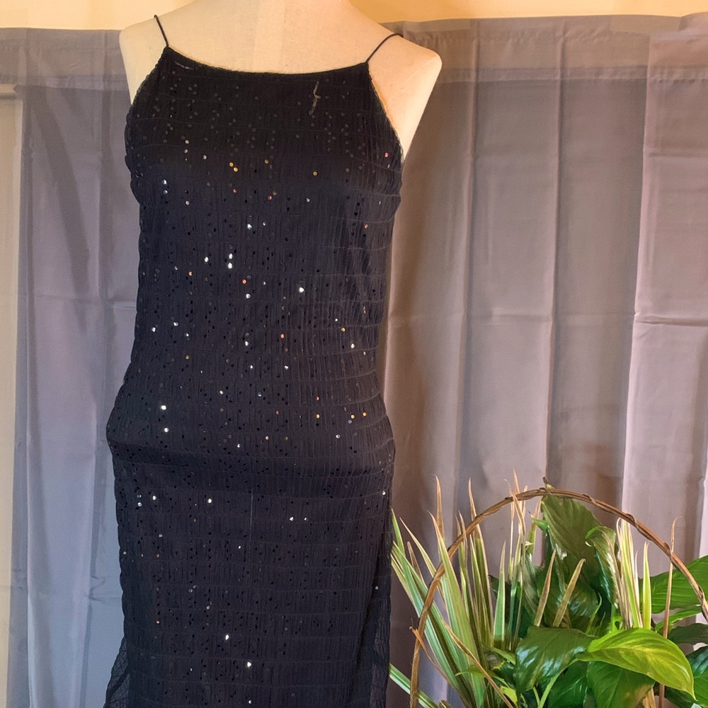 Spaghetti strap with back out style . Sheer black fabric with slip lining.